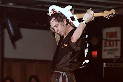 Image of Stevie Ray Vaughan playing the guitar passionately