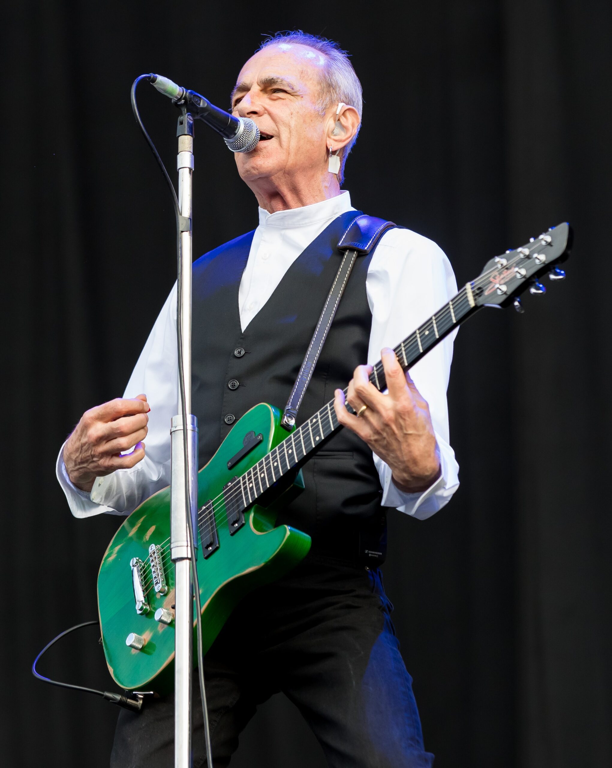 An image depicting Francis Rossi with a green guitar