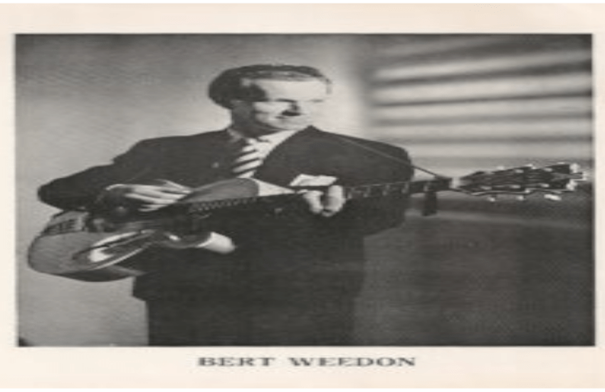 Black And White Photo Of Bert Weedon Playing A Guitar.