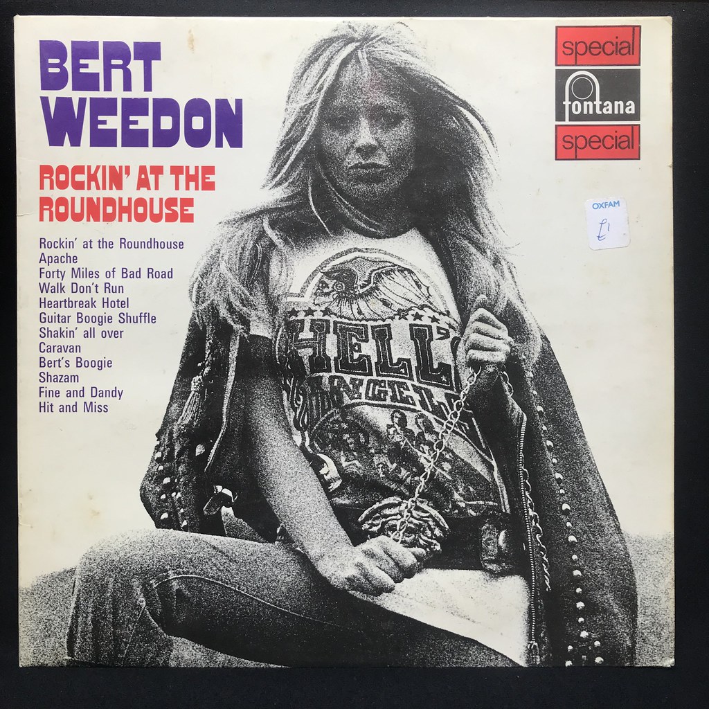 Album Cover For &Quot;Bert Weedon - Rockin' At The Roundhouse&Quot; Featuring A Woman In A &Quot;Hell'S Angels&Quot; T-Shirt And Song Titles.