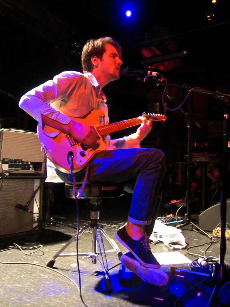 Blake Mills on stage sitting